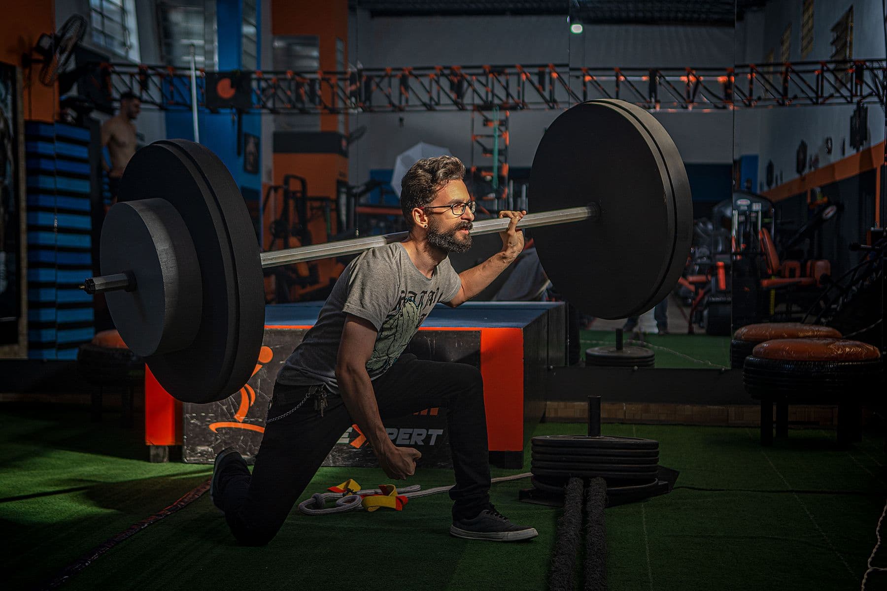 A lifter bracing under a loaded barbell squat